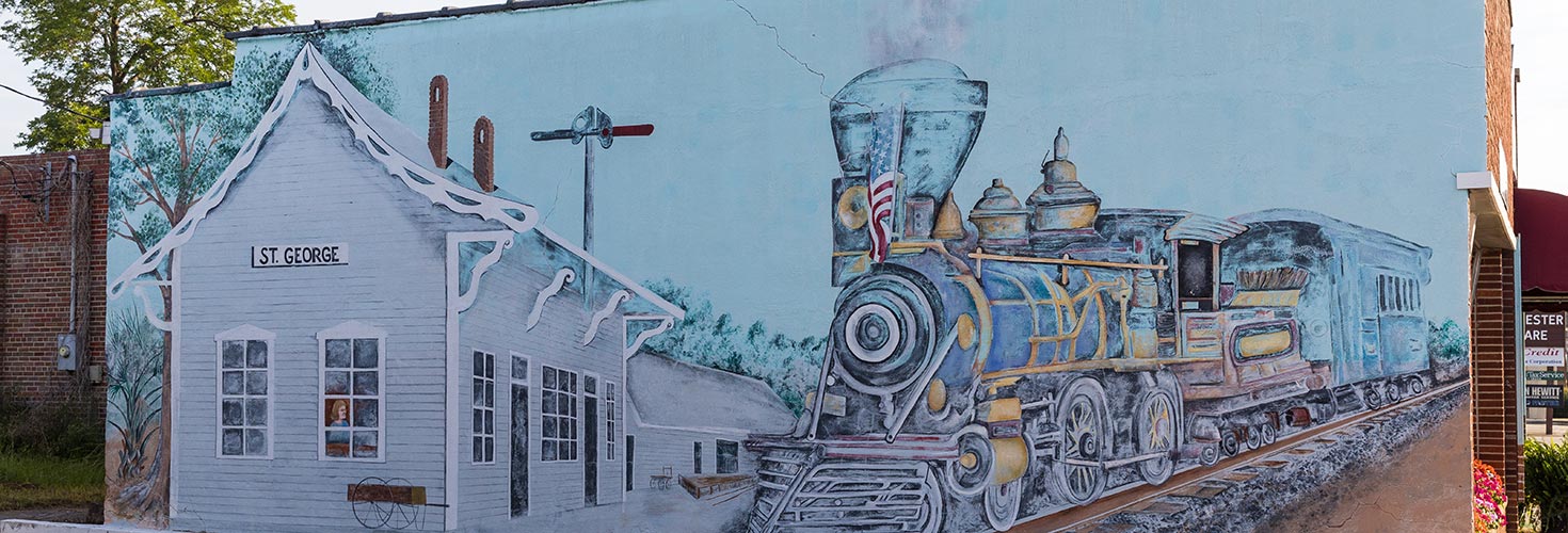 Mural of train on side of building